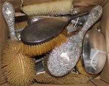 A set of three silver-mounted glass dressing case fitments, pair of brushes, various silver-