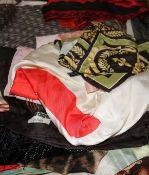 A collection of designer and other scarves and two sewing boxes