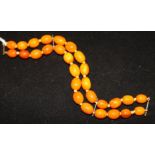 A single strand oval amber bead necklace with spacers, gross weight 20 grams, 15.5in.