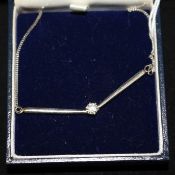 A modern 18ct white gold and solitaire diamond pendant necklace, the round cut stone weighing