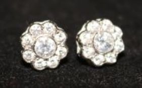 A pair of 18ct white gold and diamond cluster earrings.