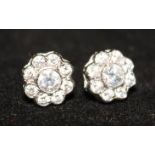 A pair of 18ct white gold and diamond cluster earrings.