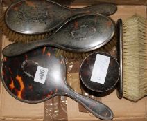 A 1920's six piece silver and tortoiseshell mounted dressing table set.