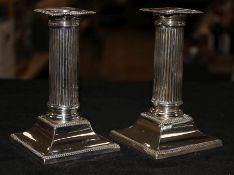 A pair of silver dwarf corinthian column candlesticks, Sheffield 1912, Lee & Wigfull