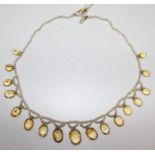 A mid 20th century seed pearl and citrine choker fringe necklace, set with seventeen graduated