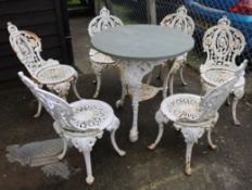 A set of six Victorian cast iron garden chairs and a similar slate topped table