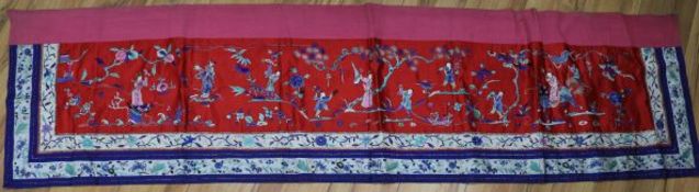 A Chinese red satin embroidered panel