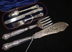 A pair of Victorian silver fish servers and a silver three-piece Christening set
