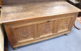 An 18th century style carved oak coffer, W.137cm