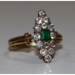 A gold, emerald and diamond cluster marquise shaped ring, size K.