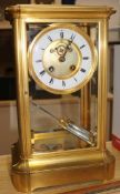A French gilt brass four glass mantel clock, with white enamelled Roman chapter ring, H 14in