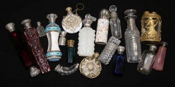 A collection of silver mounted glass scent bottles