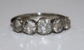 A 1940's/1950's 18ct white gold and graduated five stone diamond ring, size J.