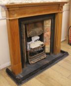 A tiled fire place and fire surround, W.137cm