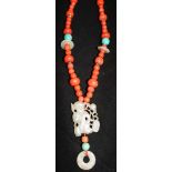 A carved jade, coral and hardstone bead necklace with silver gilt clasp, 32in.