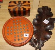 A treen solitaire board and marbles, a parquetry box and treen 'leaf' tray