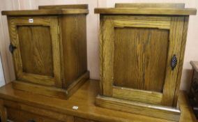 A pair of oak panelled side cupboards, W.50cm