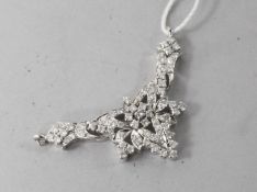 A white gold and diamond encrusted pendant, 1.5in.