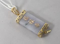 A gold mounted rectangular jade pendant, inset with Chinese characters, 1.25in.