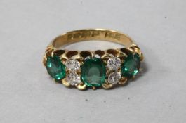 An Edwardian 18ct gold, green doublet and diamond half hoop ring, size