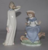 A Nao figure of a girl sitting on a wheelbarrow and one other (2)
