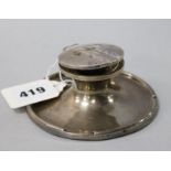 A silver capstan inkwell.