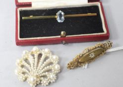 Two gold brooches and a seed pearl brooch.