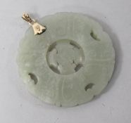 A gold mounted circular carved jade pendant, 2in.