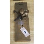 An Etas No. 11 brass 'Penny in the Slot' door lock with key and handle