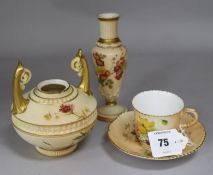 A Worcester blush ivory tea cup and saucer, and two vases