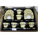 A boxed Aynsley teaset with enamelled silver spoons