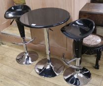 A black and chrome table and two bar stools, W.61cm