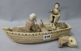 An Oriental resin figural group, man in a boat fishing and another figure