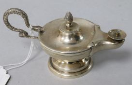 An early 20th century silver club lighter, modelled as an oil lamp with serpent handle.
