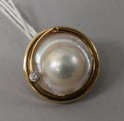 A 14ct gold, mabe pearl and diamond set circular clip, 1in.