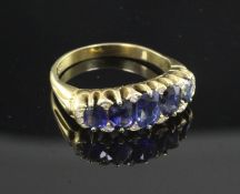 An 18ct gold and graduated five stone sapphire half hoop ring, the setting set with twelve diamond