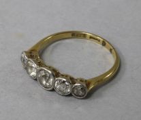 An early 20th century 18ct gold and graduated five stone diamond ring, size P.