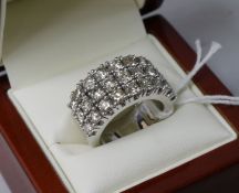 An 18ct white gold triple band diamond dress ring, set with twenty seven round brilliant cut stones,