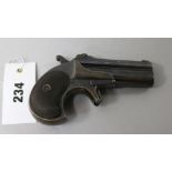 A good 2 shot Remington Deringer .41 inch Rim Fire pistol, numbered 482, tilt-up rifled barrels,