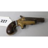 A Colt Deringer .41 inch Rim Fire pistol, brass frame rifled steel barrel stamped COLT, London proof