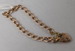 A late Victorian 9ct gold curb link bracelet with heart shaped padlock by E. Whitehouse & Son.