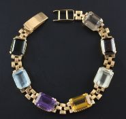 A Brazilian gold and multi gem set bracelet, mounted with seven emerald and rectangular cut stones