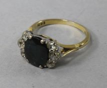 A 1980's 18ct gold, sapphire and diamond cluster ring, size J.
