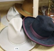 Two Stetsons and two other American hats