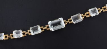 A Brazilian gold and aquamarine set bracelet, mounted with seven graduated stones, 6.5in.