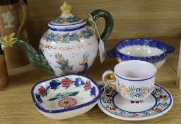A Quimper teapot with dragon spout, a cup and saucer and two later bowls