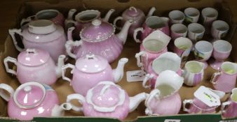 A collection of German pink lustre souvenir china, including teapots, cream jugs and eggcups (26,