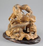 A Japanese boxwood okimono modelled as a dragon and a tiger, early 20th century, both creatures