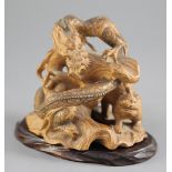 A Japanese boxwood okimono modelled as a dragon and a tiger, early 20th century, both creatures