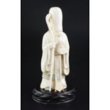 A Japanese ivory figure of Fukurokuju, early 20th century, holding a flaming jewel in his left hand,
